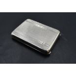 A small 1930's silver card case, of hinged rectangular form with engine-turned decoration, the