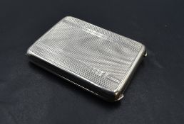 A small 1930's silver card case, of hinged rectangular form with engine-turned decoration, the