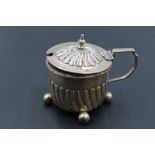 A Victorian silver mustard, of circular form with spiral gadrooning to the domed cover and body,