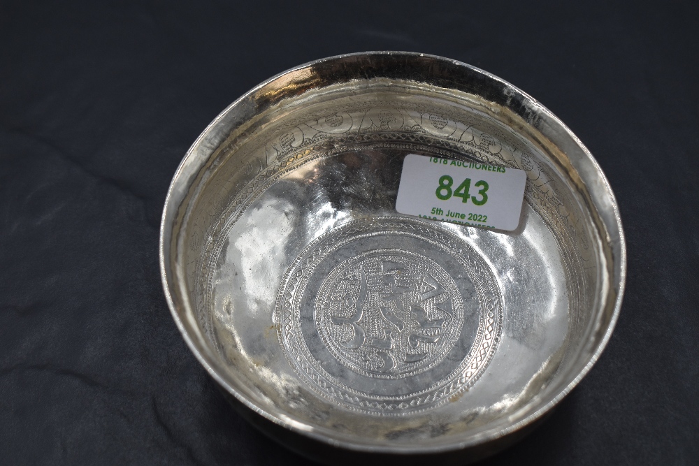 A small eastern white metal dish, of circular form with flared rim, decorated with bands of - Image 3 of 3