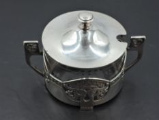 A WMF silver plated sugar bowl having clear glass liner and Art Nouveau style cover having pierced