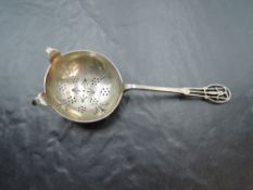 A 1940's silver tea strainer, with pierced circular bowl and slender stem with pierced terminal,