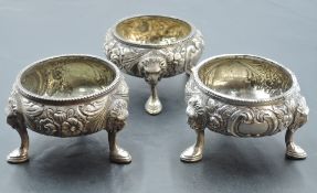 A group of three Victorian silver salts, embossed with foliate decoration the three hoof form feet