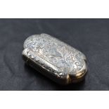 A Victorian silver vesta case, of lobed rectangular form, engraved with folaite scrolls, the