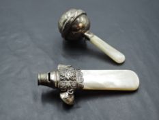 A baby's silver rattle having whistle top, and mother of pearl teething handle, Birmingham 1918,