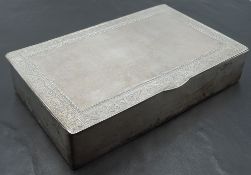 An eastern white metal box, of hinged rectangular form with engraved scrolling band to top 14.8cm