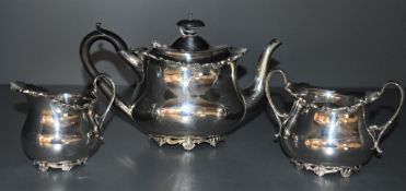 An Edwardian silver three piece breakfast tea set of oval baluster form having hard wood and loop