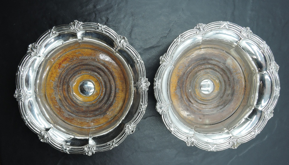 A pair of Victorian silver-plated wine coasters, of fluted circular form with ornamented and