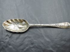 A Georgian silver berry spoon having gilt wash to fluted bowl with berry decoration, moulded
