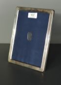 A silver photograph frame of plain rectangular form having navy velvet easel stand, Sheffield