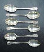 A group of six Edwardian silver dessert spoons, each with fluted edge detail and scrolled