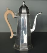 A 1960's silver coffee pot, of spreading octagonal form with domed finial topped hinged cover and