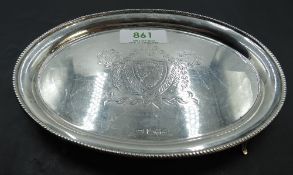 An early 20th century silver teapot stand, of oval form with beaded rim enclosing the engraved