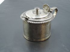 A Victorian silver mustard pot of plain cylindrical form having gadrooned rim and scallop shell