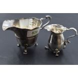 A 1920's silver cream jug of circular form with generous spout and moulded central band, raised on