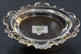 A pair of Edwardian silver dishes, of oval form with broad C-scroll moulded rim, Marks for