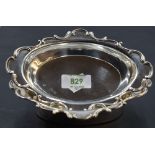 A pair of Edwardian silver dishes, of oval form with broad C-scroll moulded rim, Marks for