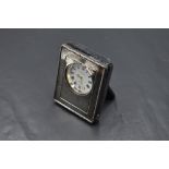 A small modern silver mounted desk clock, with moulded bead decoration and engraved initials,