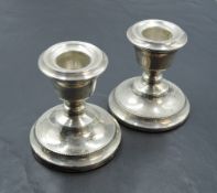 A pair of silver candle sticks of short form having removable sconces, Birmingham 1972, S J Rose &