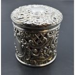 A Victorian silver mounted cranberry glass jar, of circular form, the foliate scroll moulded pull-