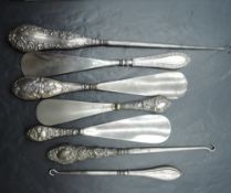 A selection of late 19th/early 20th century silver handled/mounted shoe horns and button hooks,