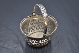 A Dutch white metal basket, of oval form with pierced over handle and body with beaded rims, Dutch
