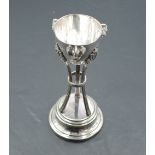 A continental white metal trophy, of half-egg form with cockerel mask ornaments, supported by