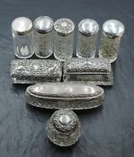 A selection of silver topped glass dressing table wares, of varying sizes, shapes, dates and makers,