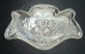 An Edwardian silver tray, of Art Nouveau design, the shaped and moulded outline enclosing cherubs
