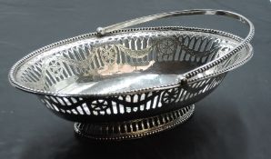 A Georgian silver sweetmeat basket of boat form having pierced and bright cut decoration, beaded