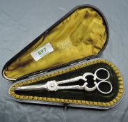 A pair of cased silver plated grape scissors, of traditional design, the shaped and plush lined case