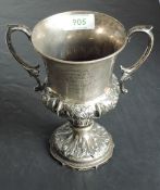 A Victorian silver trophy cup having moulded loop handles, shaped pedestal foot and moulded