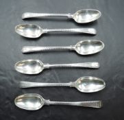 Six Georgian silver teaspoons of fiddle back form having cut edges and crest to terminals, bottom