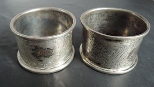 A pair of German silver napkin rings having engraved floral decoration and German inscription,