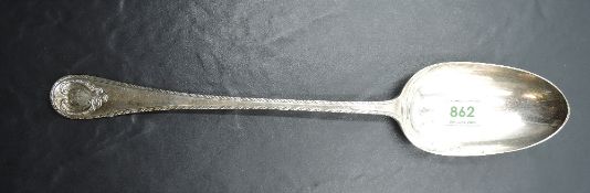 An Edwardian silver basting spoon, the stem with fluted edge finishing with a scrolled cartouche,