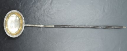 A George III silver and baleen toddy ladle, the oval bowl with reeded rim and remains of gilt