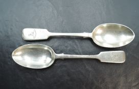 A pair of Victorian silver dessert spoons, fiddle pattern with engraved crest to terminal, marks for