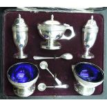 A cased silver five piece condiment set of urn form having moulded brier rose band decoration and