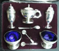 A cased silver five piece condiment set of urn form having moulded brier rose band decoration and