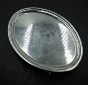 A George III Scottish silver teapot stand, of oval form with punched rim decoration and shield