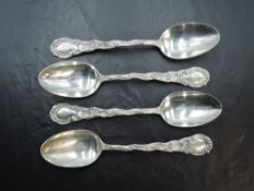 A group of four American Sterling silver spoons, the stems and terminals with C-scroll decoration,