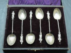 A cased set of six silver Apostle spoons, with scalloped bowls and twisted stems, marks for