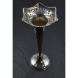 A silver trumpet vase having pierced decoration to shaped rim, tapered stem and weighted base,