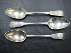 Three Queen Anne silver dessert spoons of fiddle back pattern having monogram to terminals and