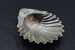 A George V silver pin dish, of scallop shell form and raised on three ball feet, marks for Sheffield