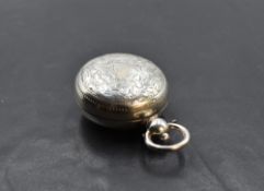 A late Victorian silver sovereign holder, of hinged circular form engraved with foliate detail,