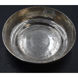 An eastern white metal bowl, hand-hammered with rolled rim and stepped base, the interior