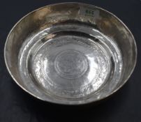 An eastern white metal bowl, hand-hammered with rolled rim and stepped base, the interior
