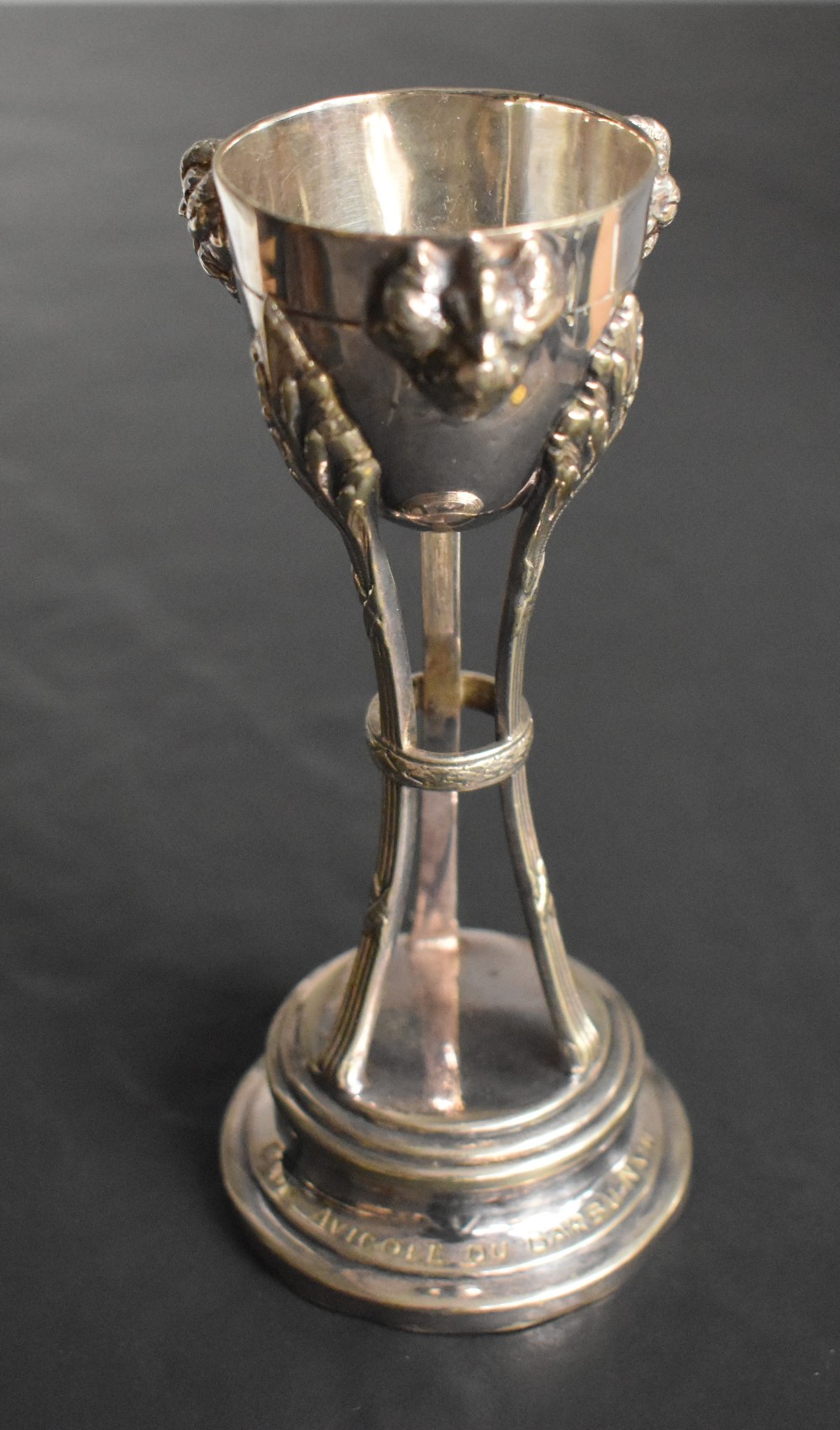 A continental white metal trophy, of half-egg form with cockerel mask ornaments, supported by - Image 2 of 4