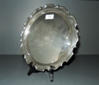 A 1920's silver salver, of circular form with moulded 'Chippendale' edge, engraved inscription to